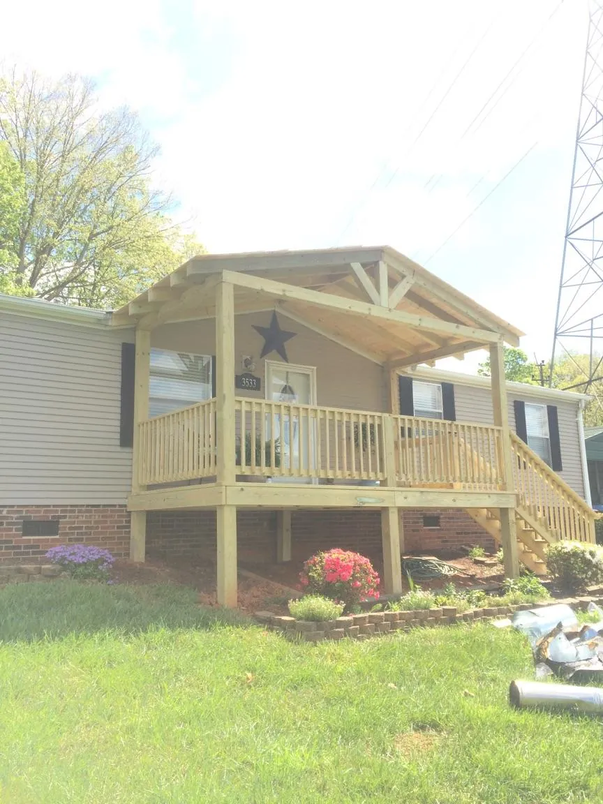 New gabled porch roof and deck railing added to a ranch home in Hull